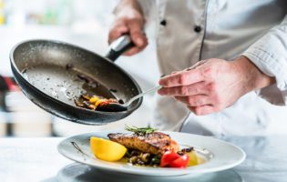 Chef finishing food in his restaurant kitchen