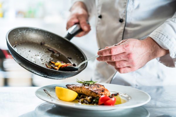 Chef finishing food in his restaurant kitchen