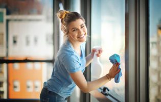 woman cleaning windows in her apartment