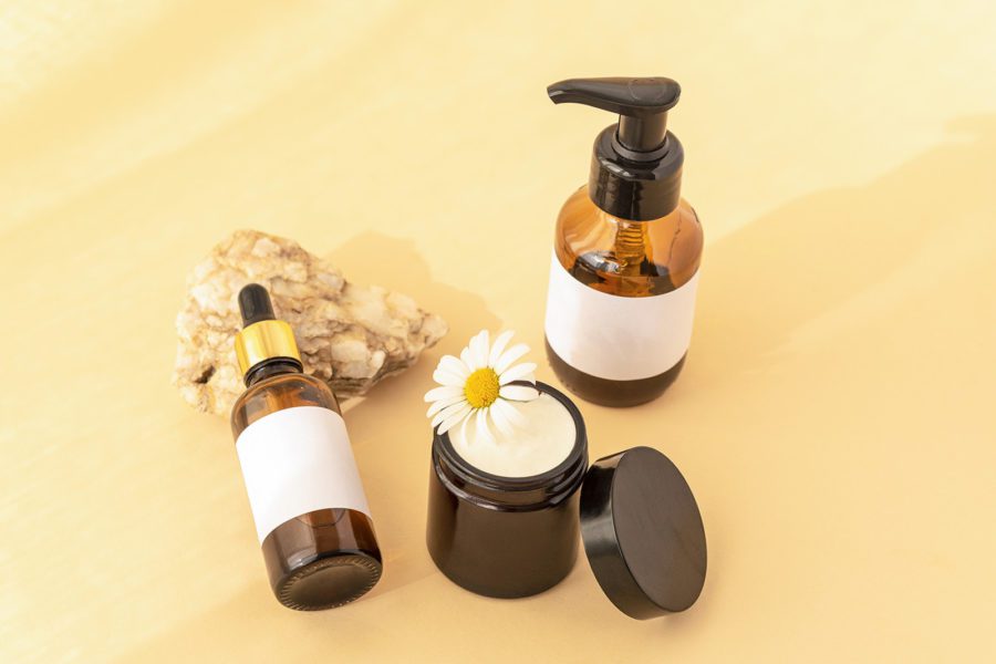 beauty-products-wash-gel-cream-jar-serum-on-natural-stone-yellow-background-top-view-skin-care-concept