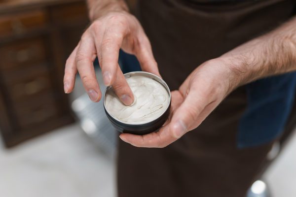 Hairdresser Using Pomade To Hair Styling