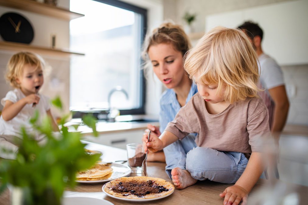 A mother and her two children in the kitchen