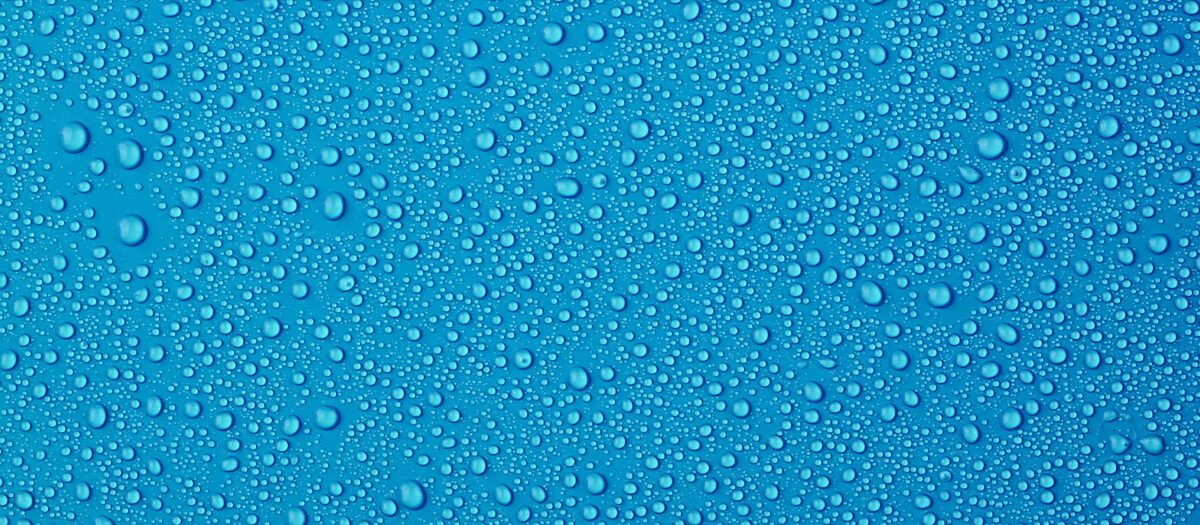 Water droplets on blue background