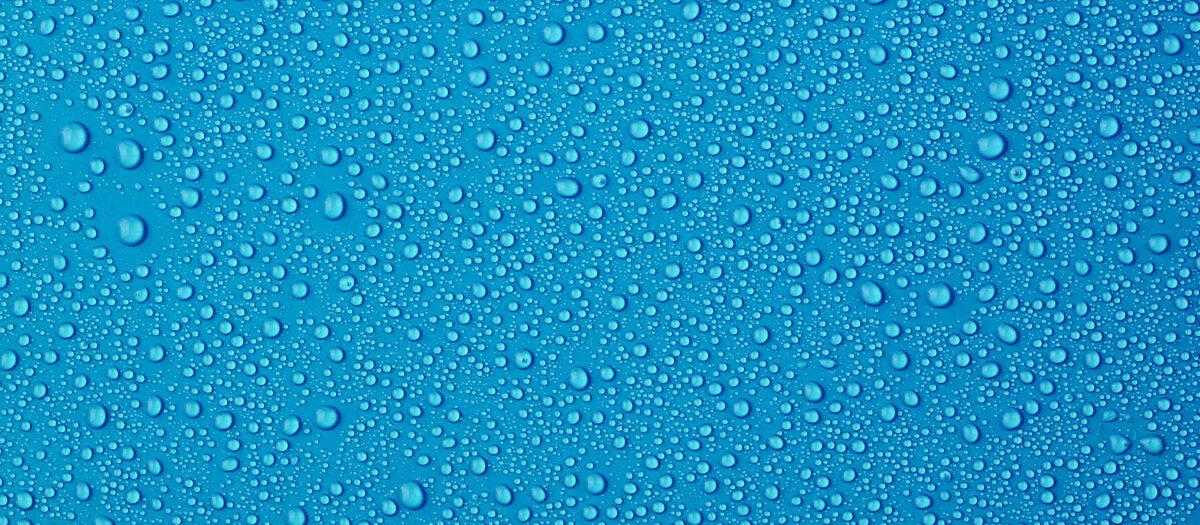 Water droplets on blue background