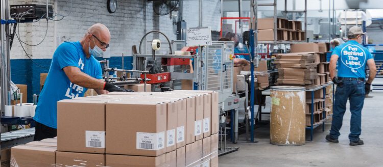 PLZ employees working with boxes in warehouse