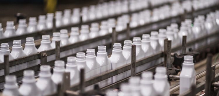 White bottles on conveyor belt