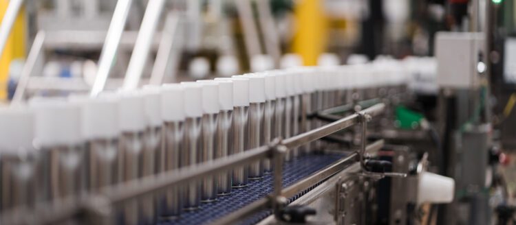 Spray bottles on assembly line