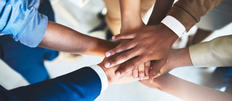 Diverse hands together to show teamwork