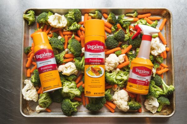 3 Vegalene Oil Sprays on a pan of vegetables.